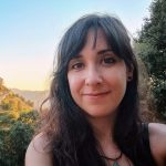 Photograph of Carmen Rosas-Pérez with a forest landscape in the background.