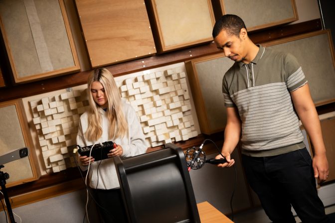 Students performing measurements in the listening room